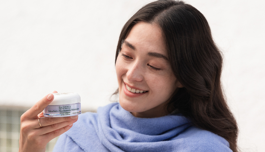 A woman holding the Bakuchiol + Niacinamide Moisturizer